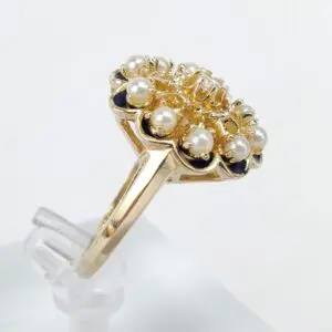 Gold ring with pearls and dark stones.