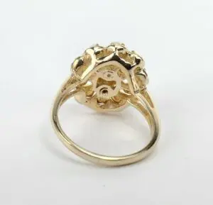 Gold ring with intricate floral design.
