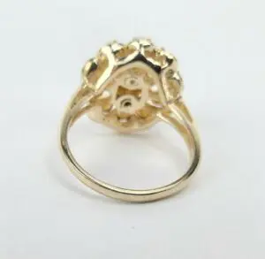 Gold ring with intricate setting design.
