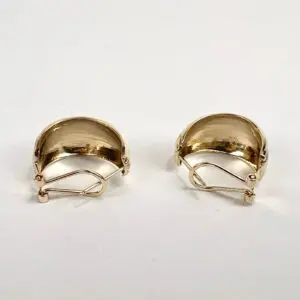 Gold clip-on earrings on white background.