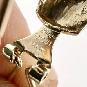 Close-up of 14K gold jewelry hallmark.