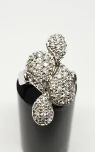 Silver ring with intricate diamond design.