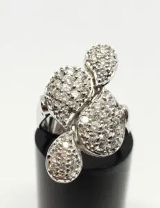 Diamond-studded silver ring with unique design.