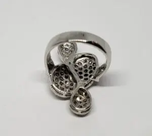 Silver ring with intricate perforated design.