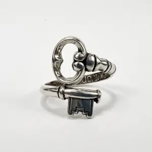 Silver ring with key-shaped design.