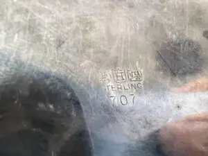Metal surface stamped with "STERLING 707" text.