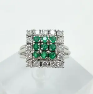 Square ring with green and white stones.