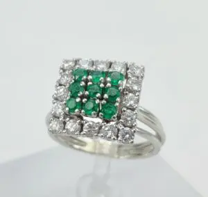 Silver ring with green and clear stones.