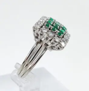 Silver ring with green and white stones.