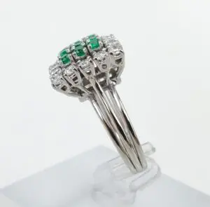 Silver ring with green and clear stones.