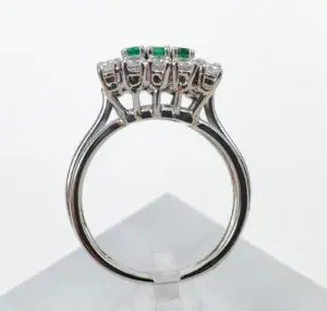 Silver ring with emerald and diamond setting.