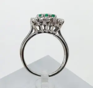 Silver ring with green gemstone details.