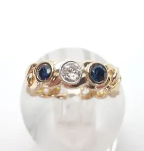 Gold ring with diamonds and sapphires.