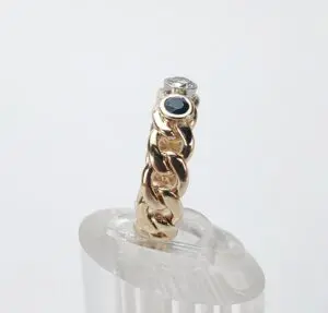 Gold chain ring with diamond and sapphire.