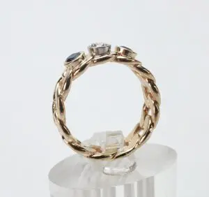 Gold braided ring with three gemstones.