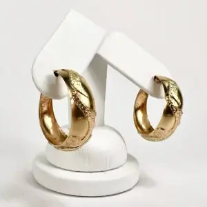 Gold hoop earrings with textured design.
