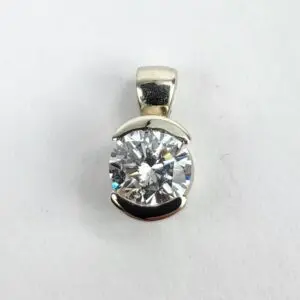 Silver pendant with large round diamond.