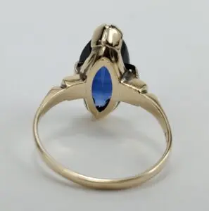 Gold ring with a blue gemstone.