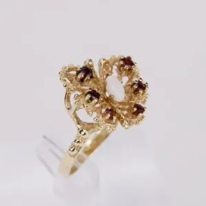 Gold ring with decorative gemstone design.