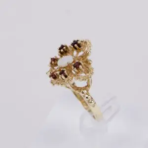 Ornate gold ring with red gemstones.