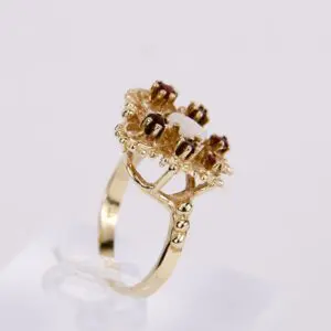 Gold ring with ornate gemstone setting.