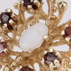 Gold brooch with opal and garnet stones.