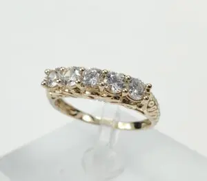 Gold ring with five sparkling diamonds.
