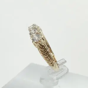 Gold ring with intricate design and diamonds.