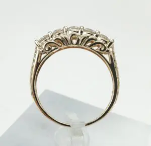 Gold ring with intricate gemstone setting.