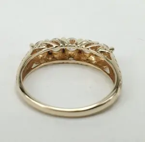 Gold ring with intricate floral design.