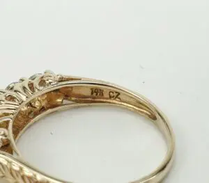 Gold ring with "14K CZ" engraving.