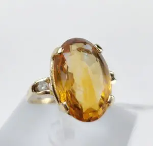 Gold ring with large amber gemstone.