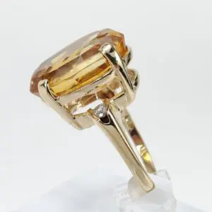 Gold ring with large amber gemstone.