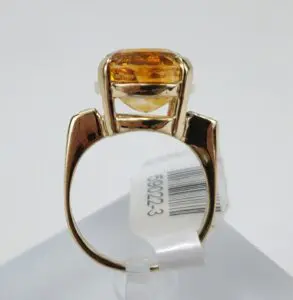 Gold ring with large amber gemstone.