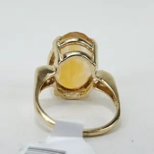 Gold ring with yellow gemstone, back view.