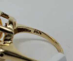 Gold ring with engraved metal stamp.