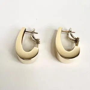 Gold hoop earrings on white background.