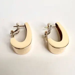 Gold hoop earrings on white background.