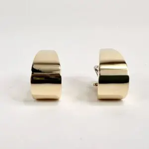 Gold rectangular cufflinks on white background.