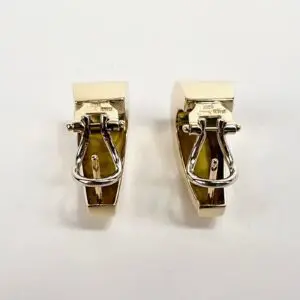 Gold and silver clip-on earrings.