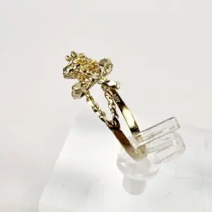 Gold ring with intricate floral design.