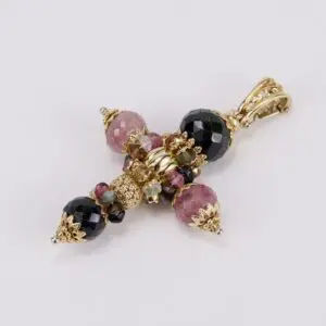 Gemstone cross pendant with gold accents.