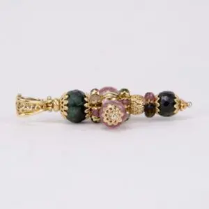 Ornate bead pendant with gold accents.