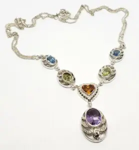 Silver necklace with colorful gemstone pendants.