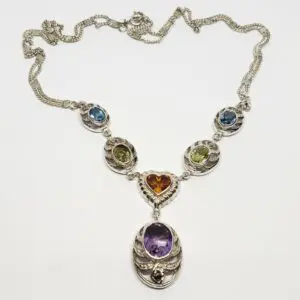 Silver necklace with colorful gemstone pendants.