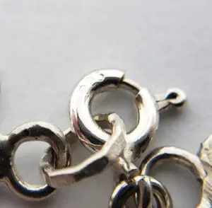 Close-up of a silver chain clasp.