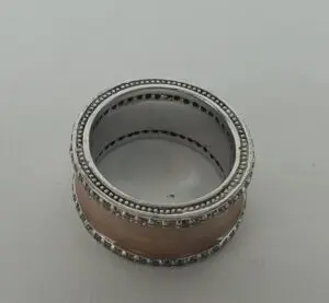 Silver and beige decorative napkin ring.