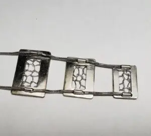 Silver bracelet with geometric rectangular design.
