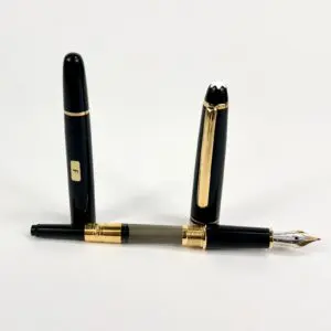 Black and gold fountain pen with cap.