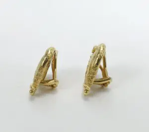 Gold textured clip-on earrings on display.